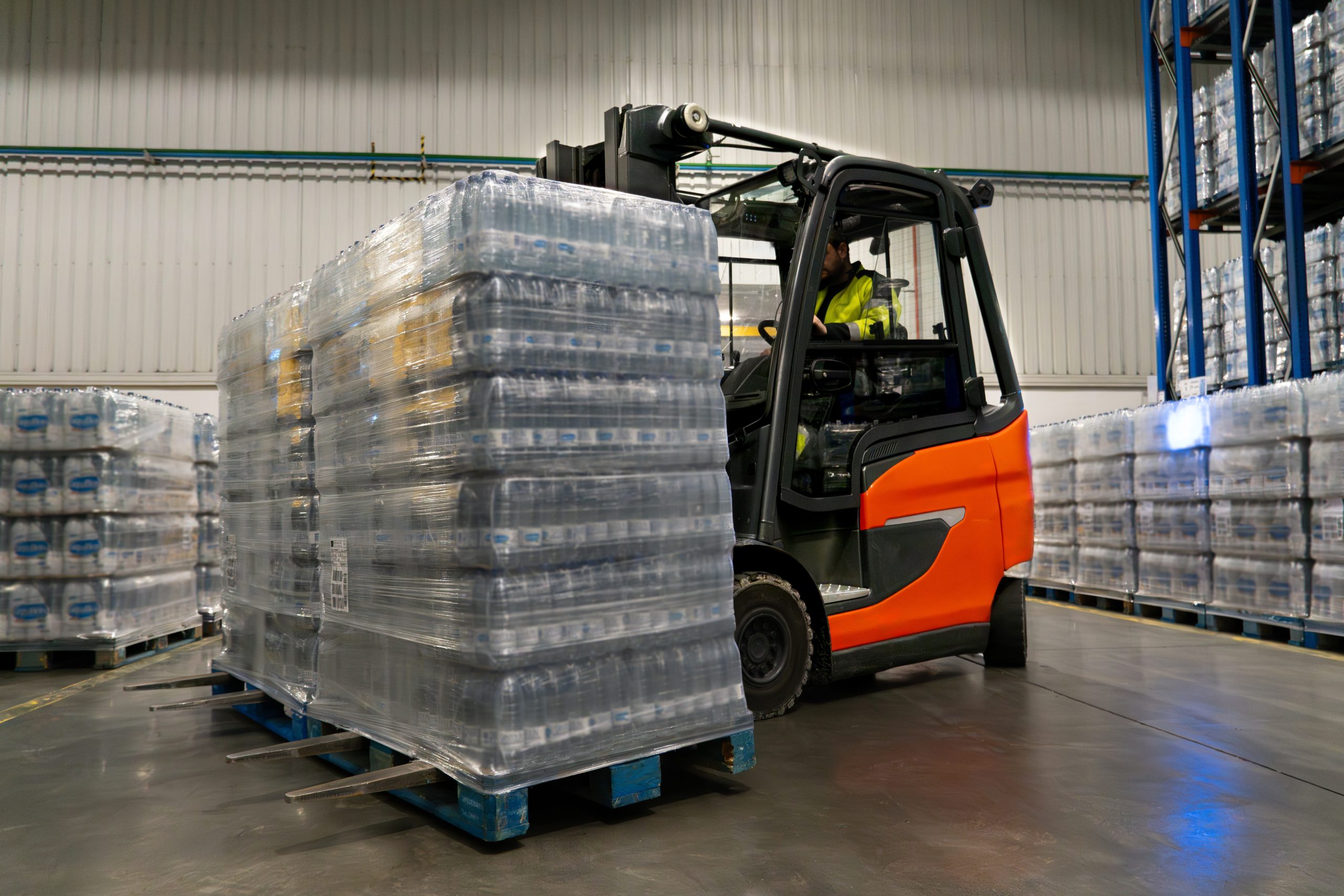 Forklift moving pallets in a cross-docking warehouse